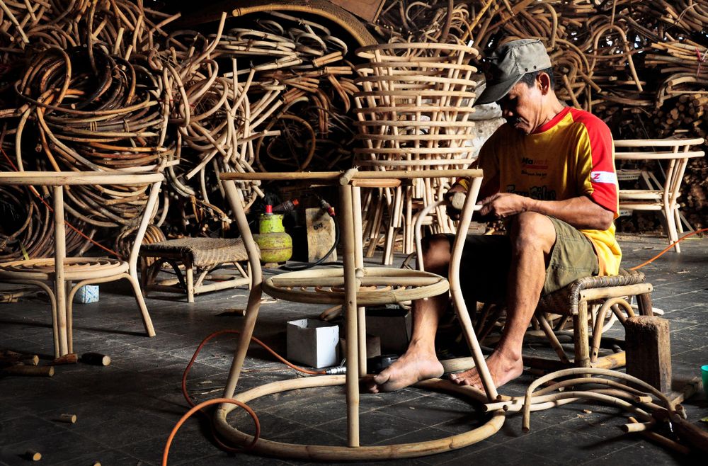 Pengrajin rotan di Cirebon Jawa Barat tengah merangkai rotan menjadi sebuah meja sebelum dipasarkan secara luas. (Foto: Shutterstock/Bastian AS)